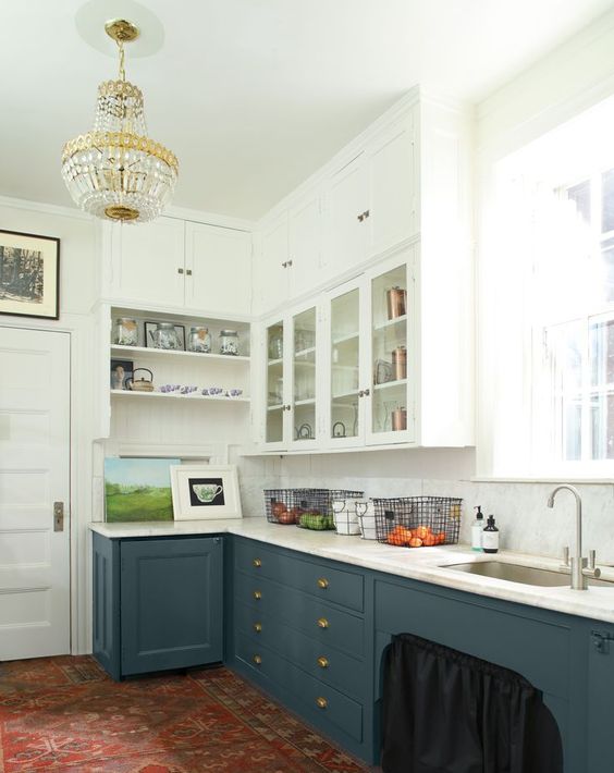 Benjamin Moore Providence Blue is one of the most sophisticated dark blue gray paint colors for cabinets in a kitchen pictured here with white overhead cabinets with glass doors